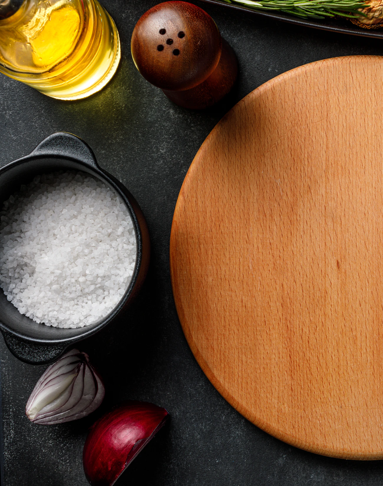 Overhead flat lay of the Foglia & Co. prep table with fresh herbs, tomatoes and plated dishes on wood